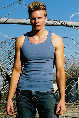 Davey T Hamilton in front of prison fence